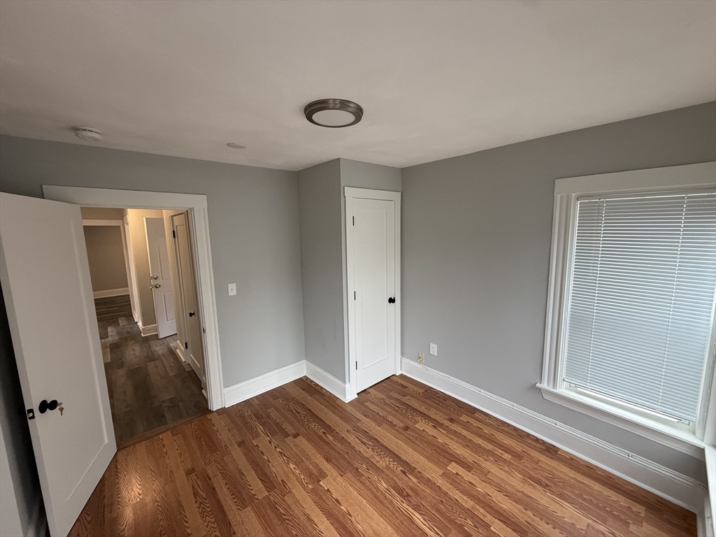 1922 Columbus Avenue, Unit 2 Boston, MA 02119 - Photo 15 of 22 a view of a room with wooden floor and bathroom