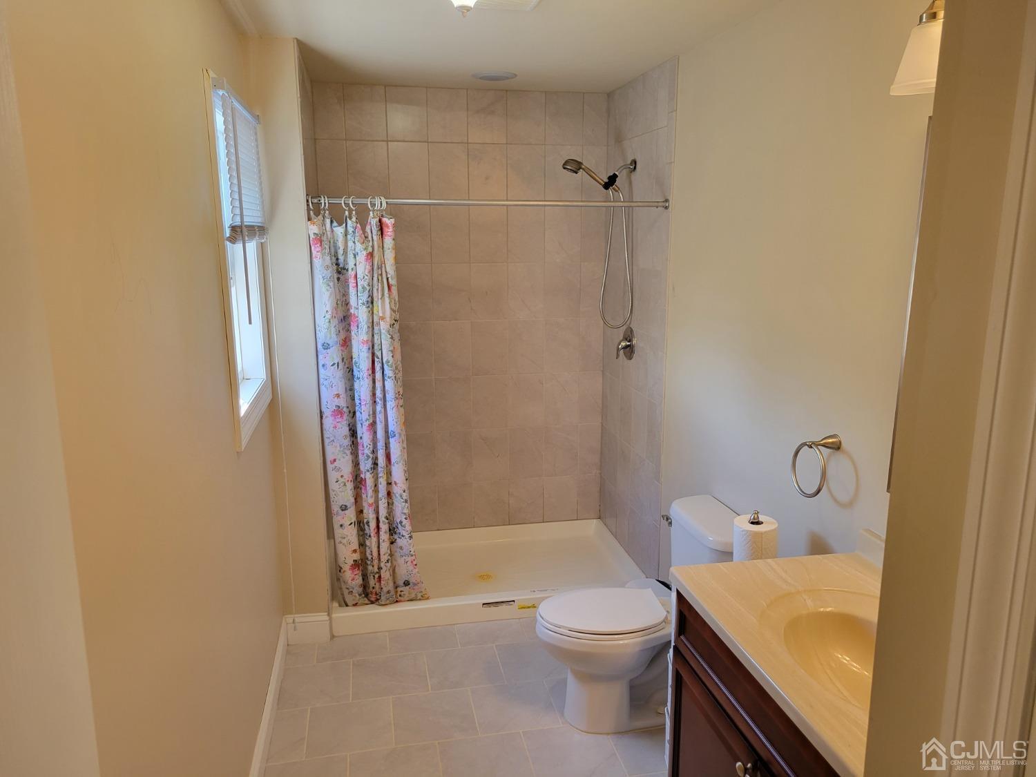 4 Kenmore Road Edison, NJ 08817 - Photo 35 of 55 a bathroom with a sink a toilet and shower