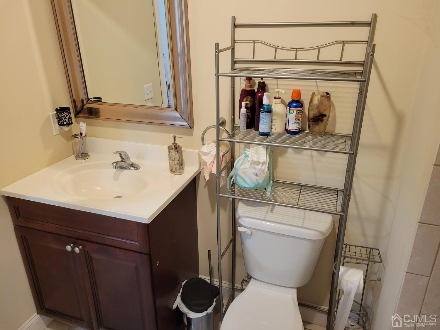 4 Kenmore Road Edison, NJ 08817 - Photo 45 of 55 a bathroom with a sink a toilet and a mirror
