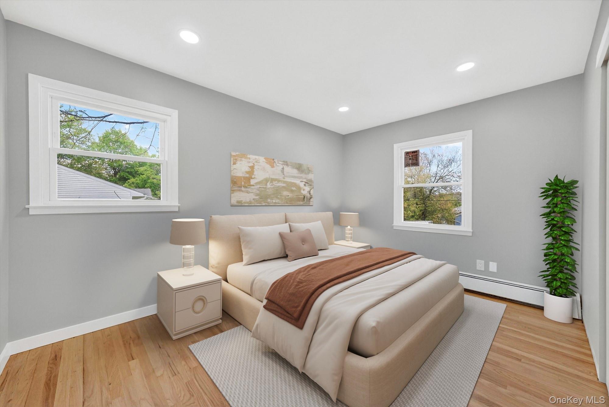 8 Mockingbird Lane Poughkeepsie, NY 12601 - Photo 13 of 32 a bedroom with a large bed and a potted plant