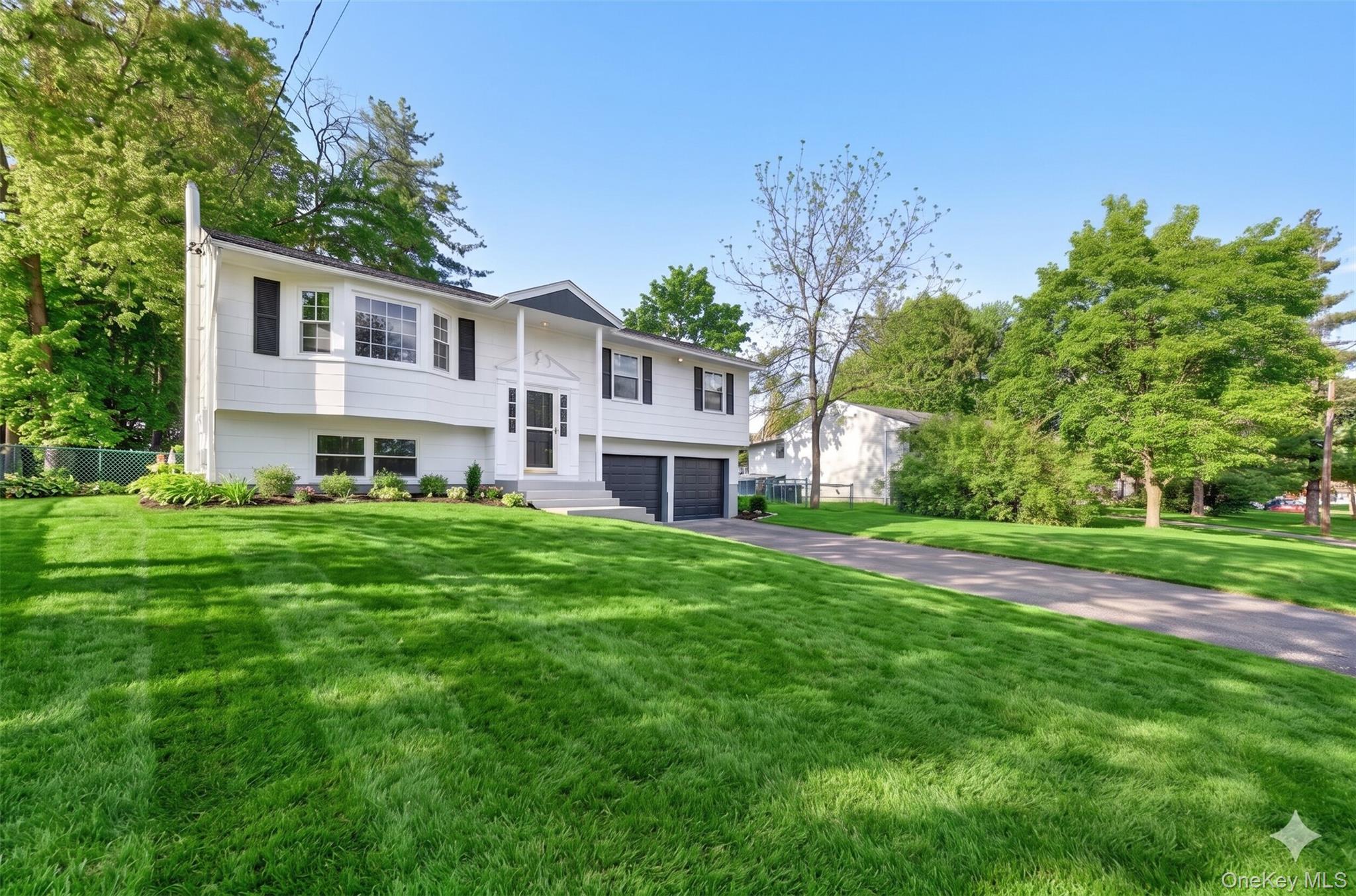 8 Mockingbird Lane Poughkeepsie, NY 12601 - Photo 2 of 32 a front view of a house with a yard table and chairs