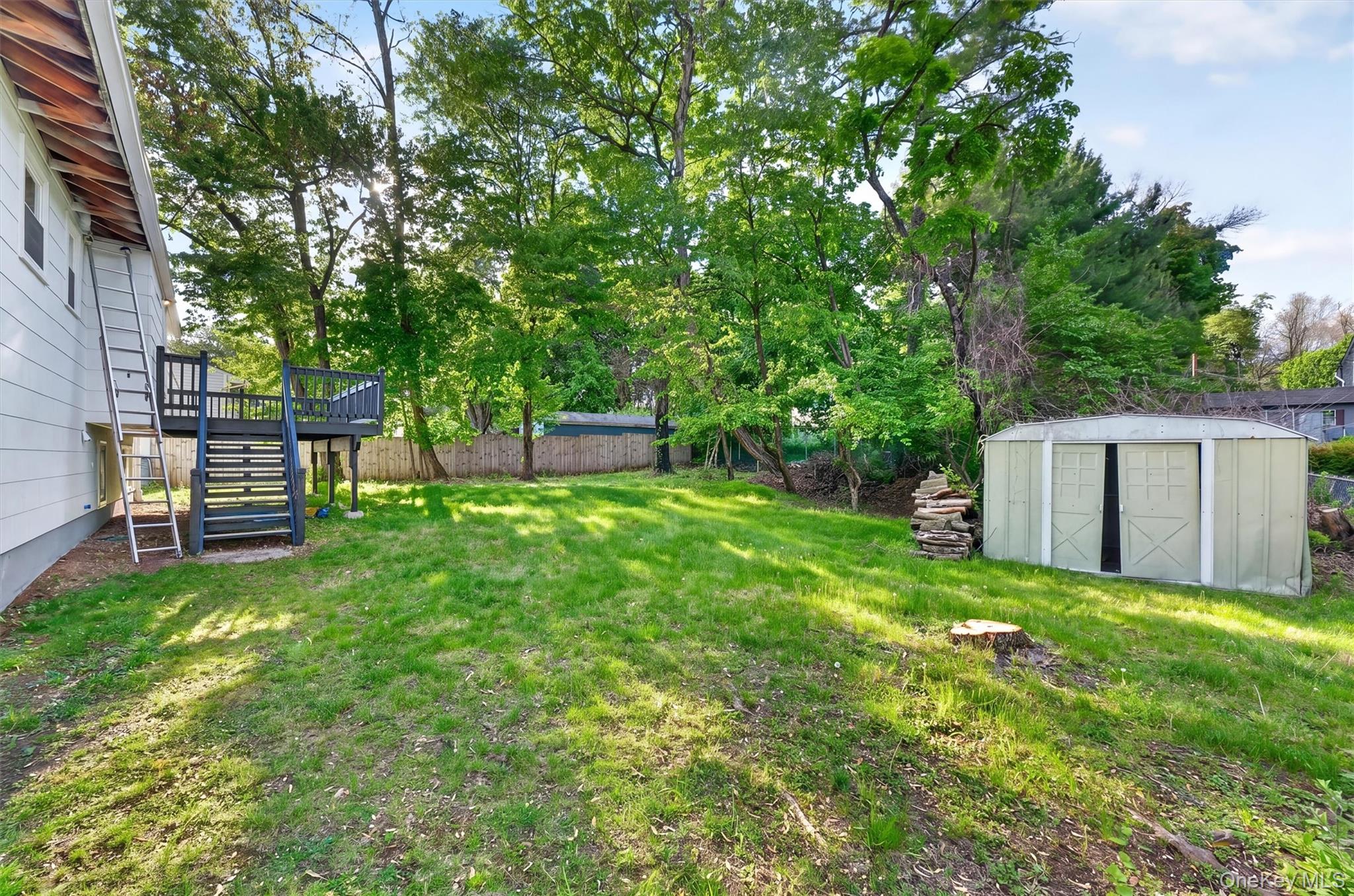 8 Mockingbird Lane Poughkeepsie, NY 12601 - Photo 25 of 32 a view of a backyard with table and chairs and a large tree