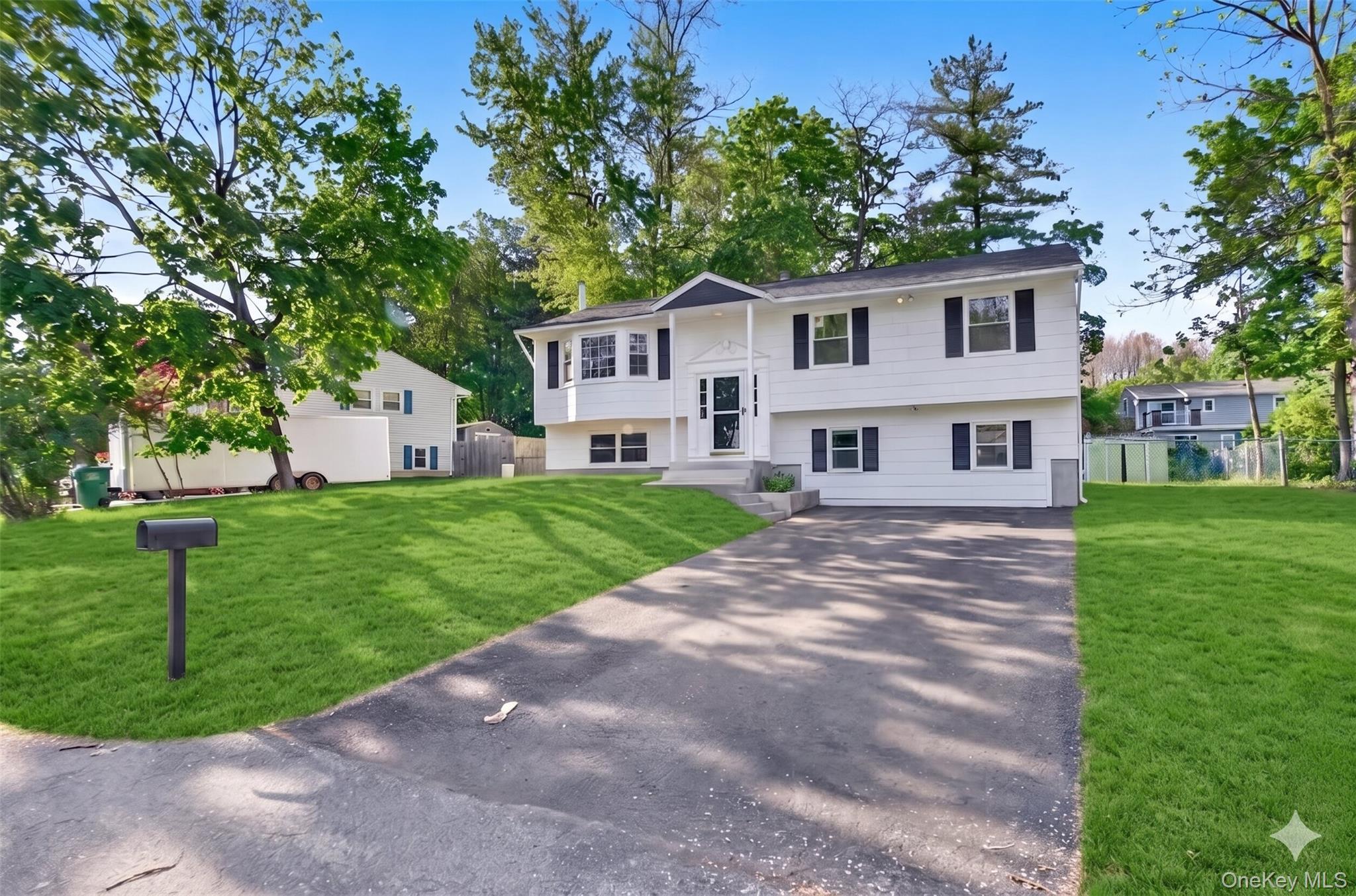8 Mockingbird Lane Poughkeepsie, NY 12601 - Photo 3 of 32 a front view of a house with a yard and tree