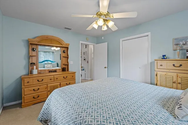 a bedroom with a bed and a mirror on dresser