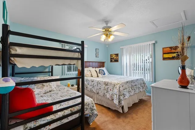 a bedroom with a bed a dresser and next to a window