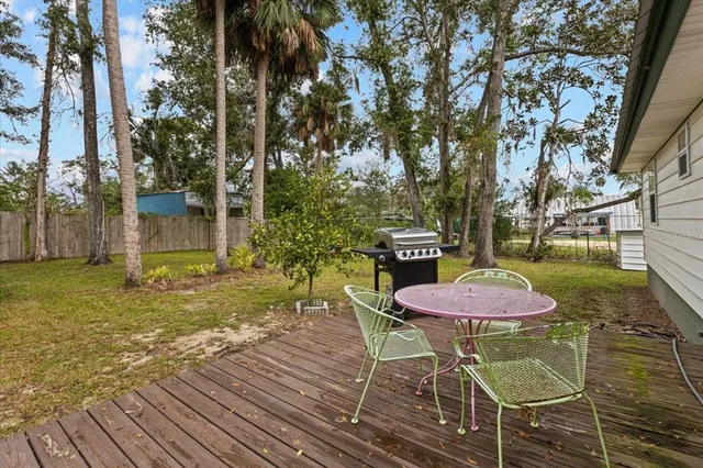 a table and chairs in a wooden deck