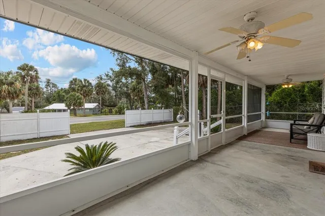 a view of a balcony with furniture and wooden floor