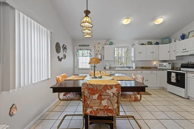 a living room with stainless steel appliances kitchen island granite countertop furniture and a window