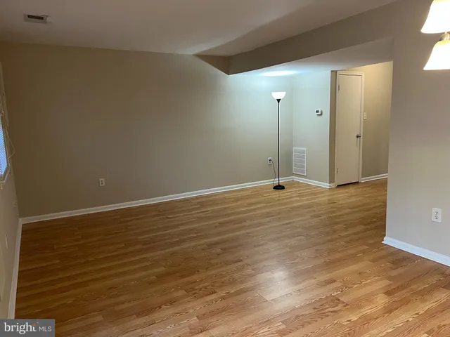 a view of a room with wooden floor