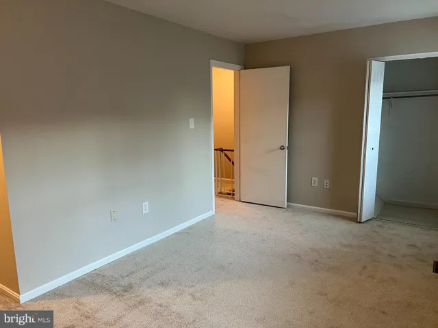 an empty room with closet and a window