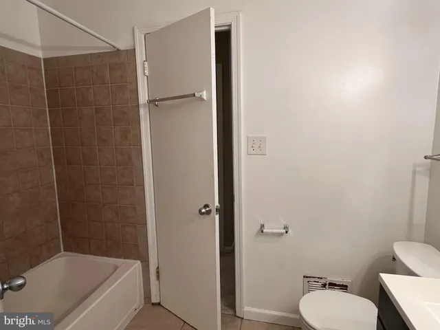 a bathroom with a toilet and shower