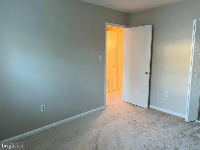 a view of an empty room and a window