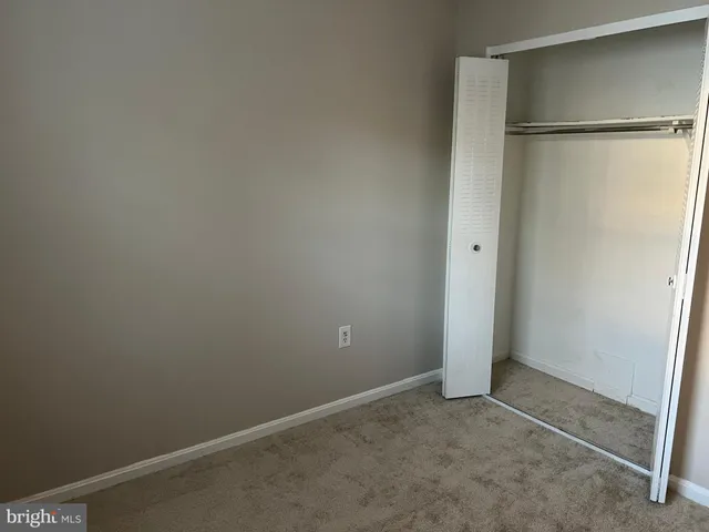 a car parked in front of a white house