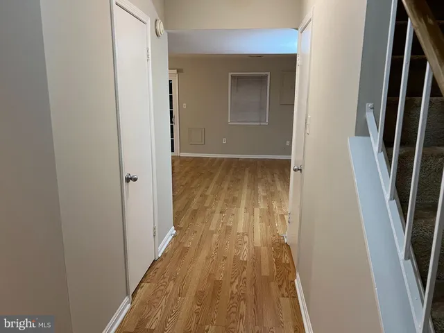 a view of closet with wooden floor