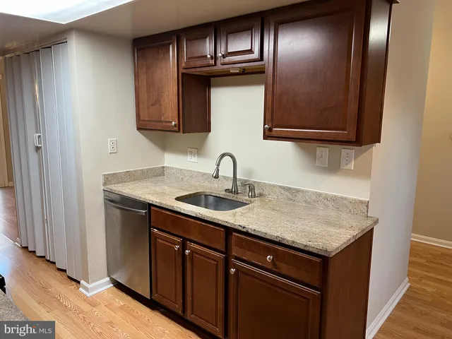 a view of a sink a mirror and cabinets