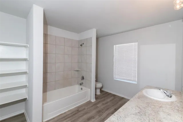 a bathroom with a bathtub and shower