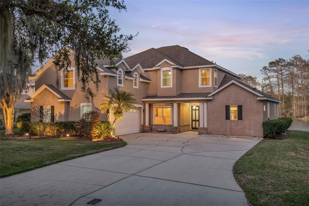 1425 Riviera Drive Kissimmee, FL 34744 - Photo 3 of 82 a front view of a house with a yard
