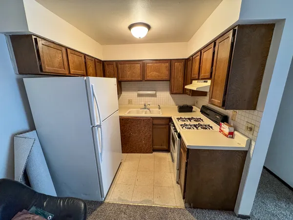 a utility room with refrigerator washer and dryer
