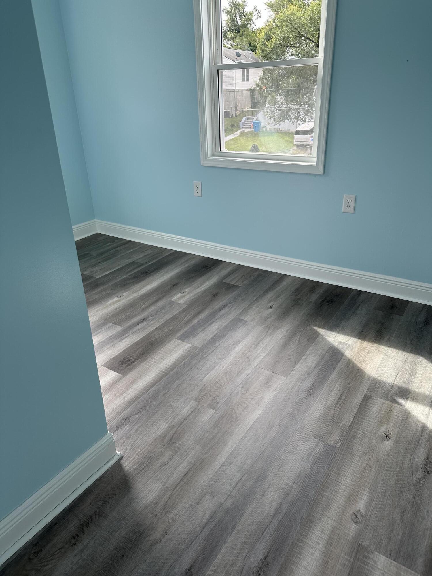 707 Rutherford Avenue Northwest Roanoke, VA 24016 - Photo 17 of 22 an empty room with wooden floor and windows