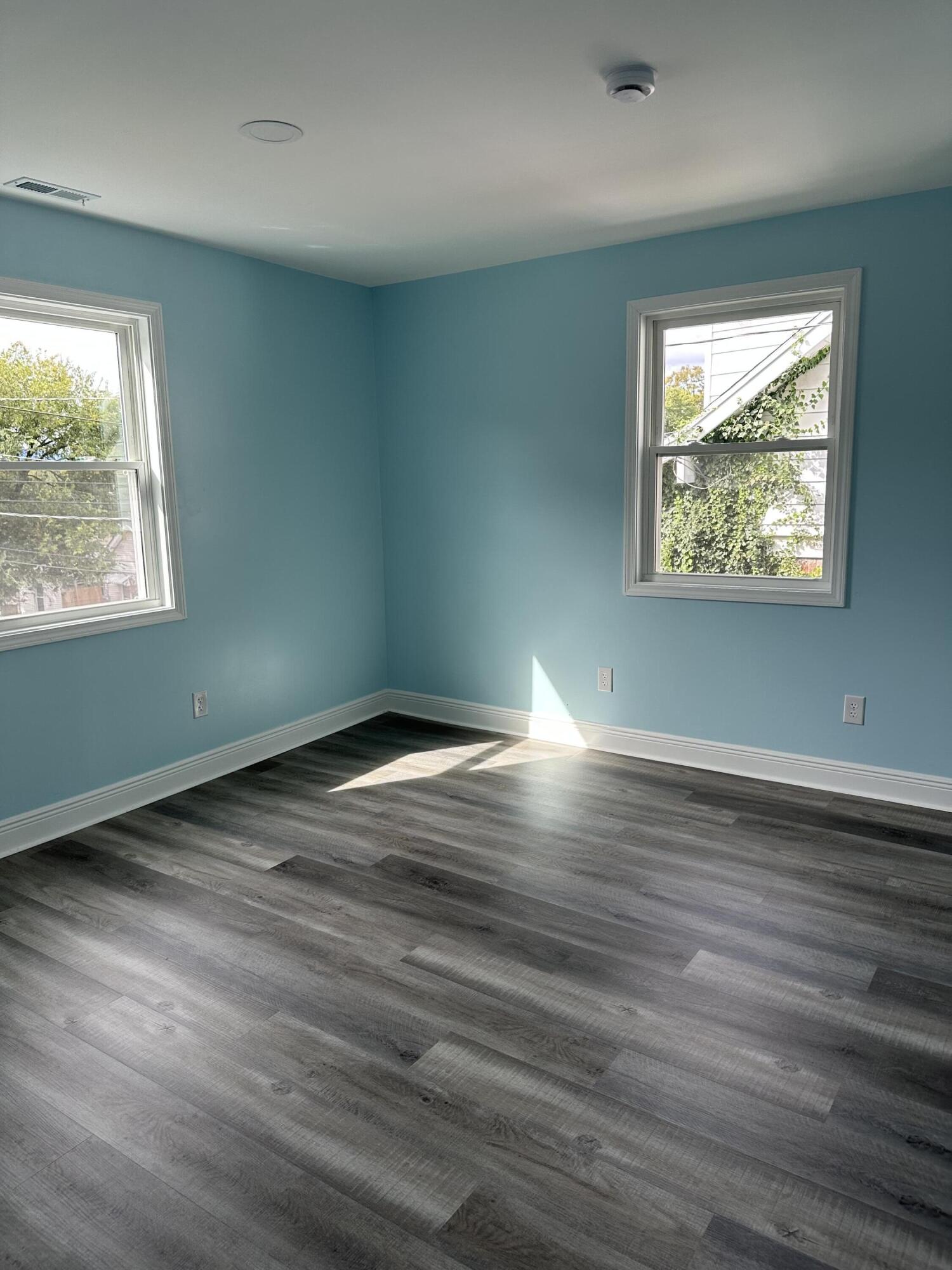 707 Rutherford Avenue Northwest Roanoke, VA 24016 - Photo 18 of 22 an empty room with wooden floor and windows