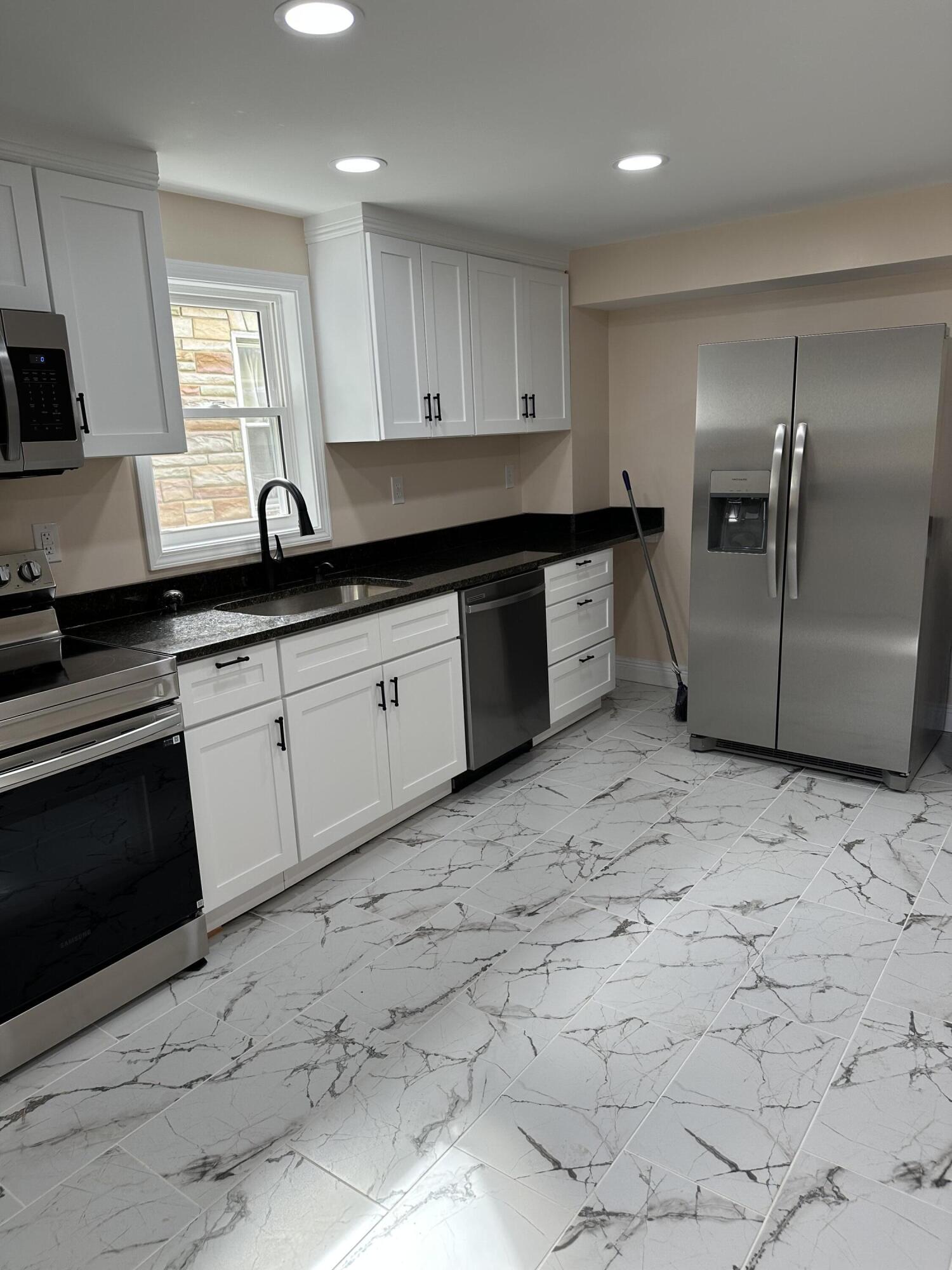 707 Rutherford Avenue Northwest Roanoke, VA 24016 - Photo 8 of 22 a kitchen with granite countertop a stove a sink and a microwave