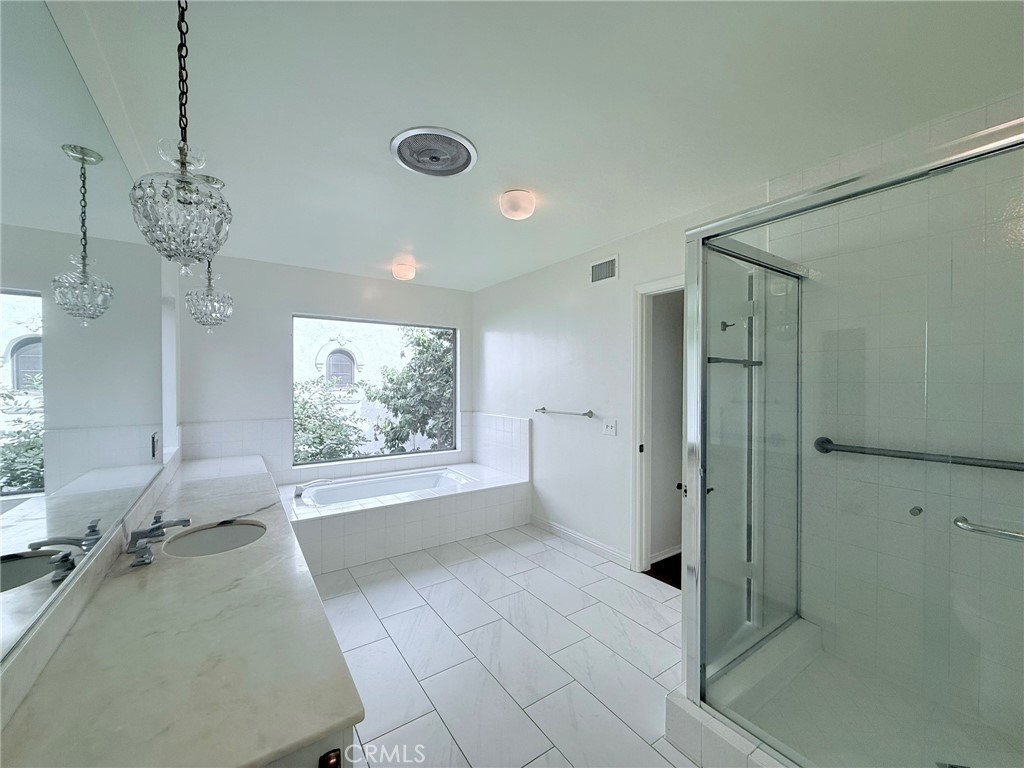 1727 Euston Road San Marino, CA 91108 - Photo 22 of 36 a spacious bathroom with a granite countertop sink a large mirror and a bathtub