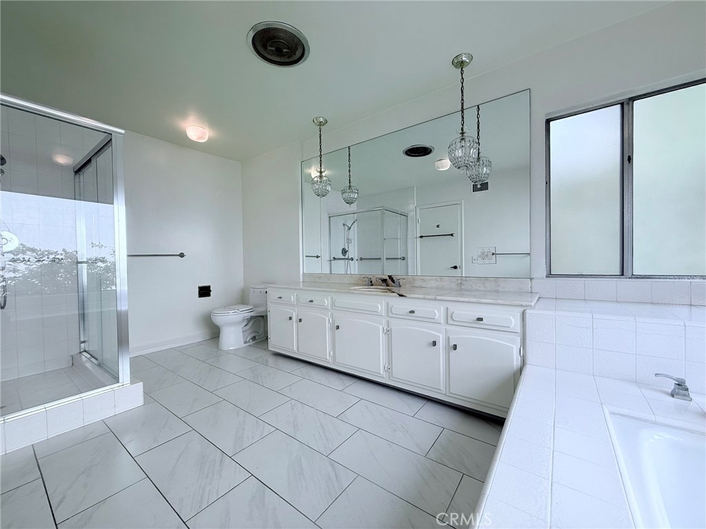 1727 Euston Road San Marino, CA 91108 - Photo 23 of 36 a large white bathroom with a granite countertop sink a toilet a mirror and shower