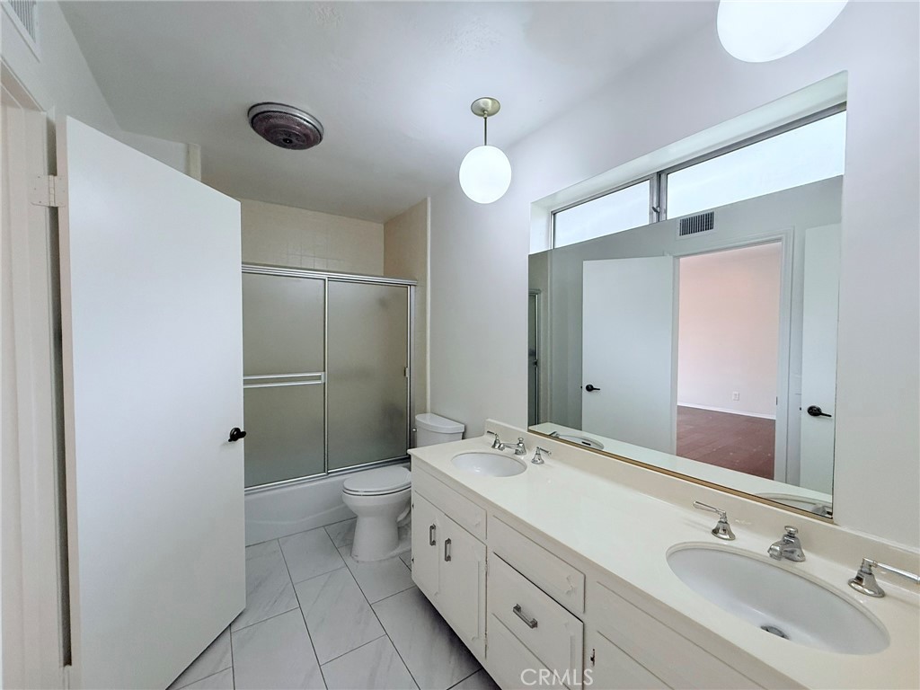 1727 Euston Road San Marino, CA 91108 - Photo 29 of 36 a bathroom with a double vanity sink toilet and shower