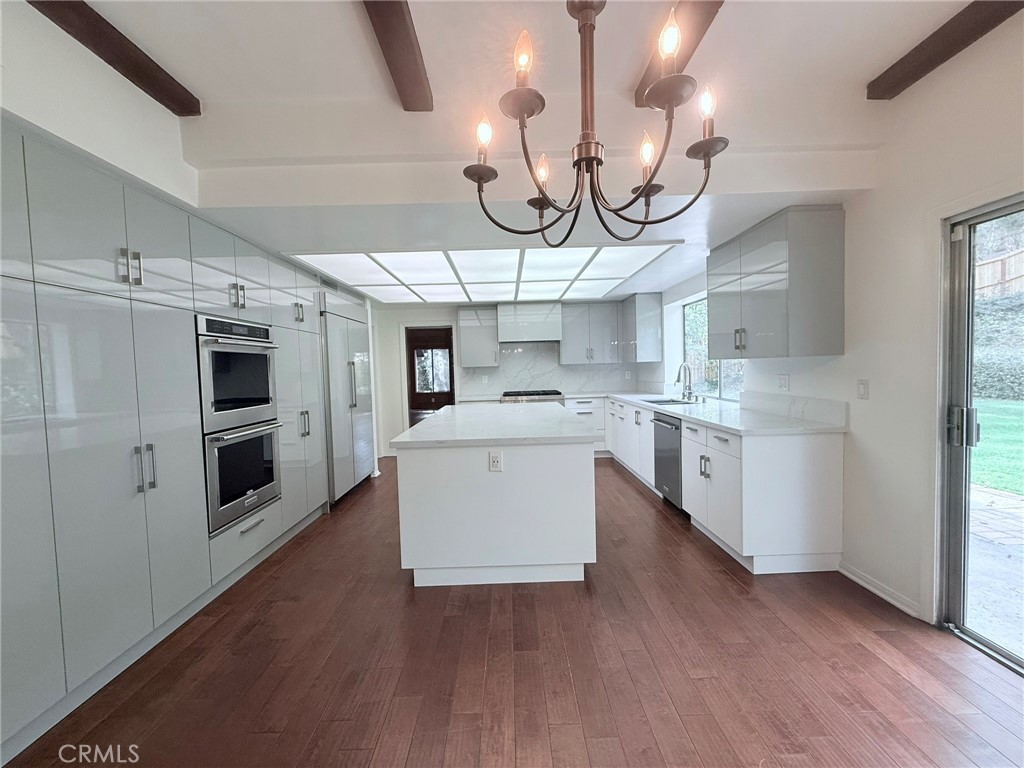 1727 Euston Road San Marino, CA 91108 - Photo 8 of 36 a large kitchen with stainless steel appliances kitchen island a large counter space a sink and cabinets