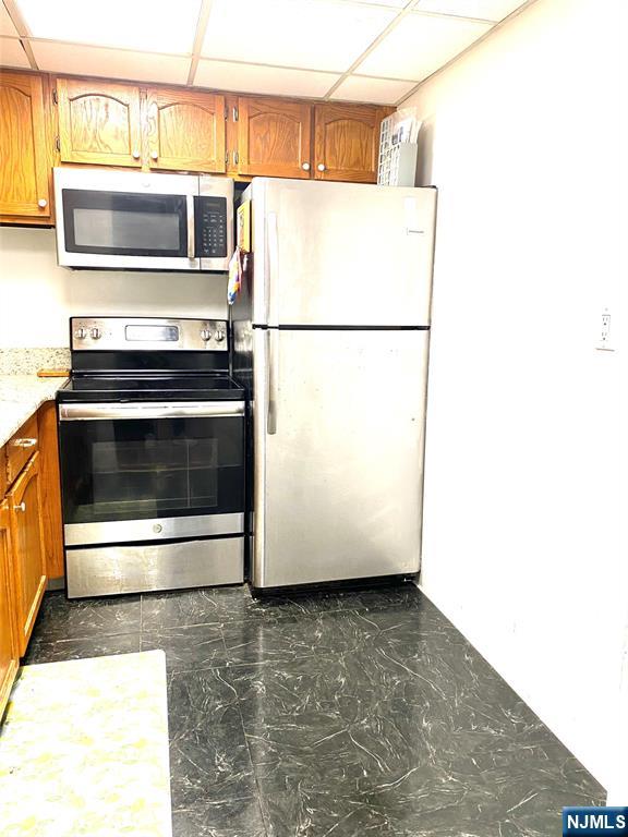 1111 River Road, Unit H21 Edgewater, NJ 07020 - Photo 5 of 8 a kitchen with a refrigerator and a stove