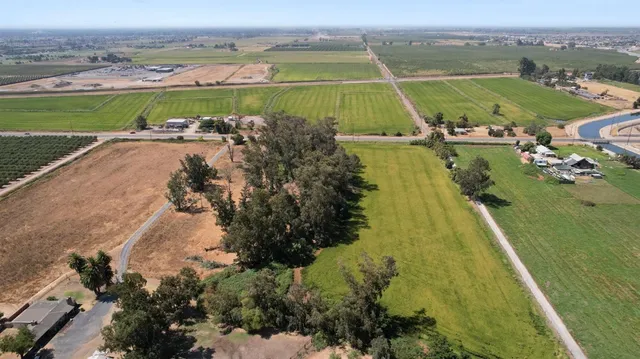 an aerial view of a residential houses with outdoor space