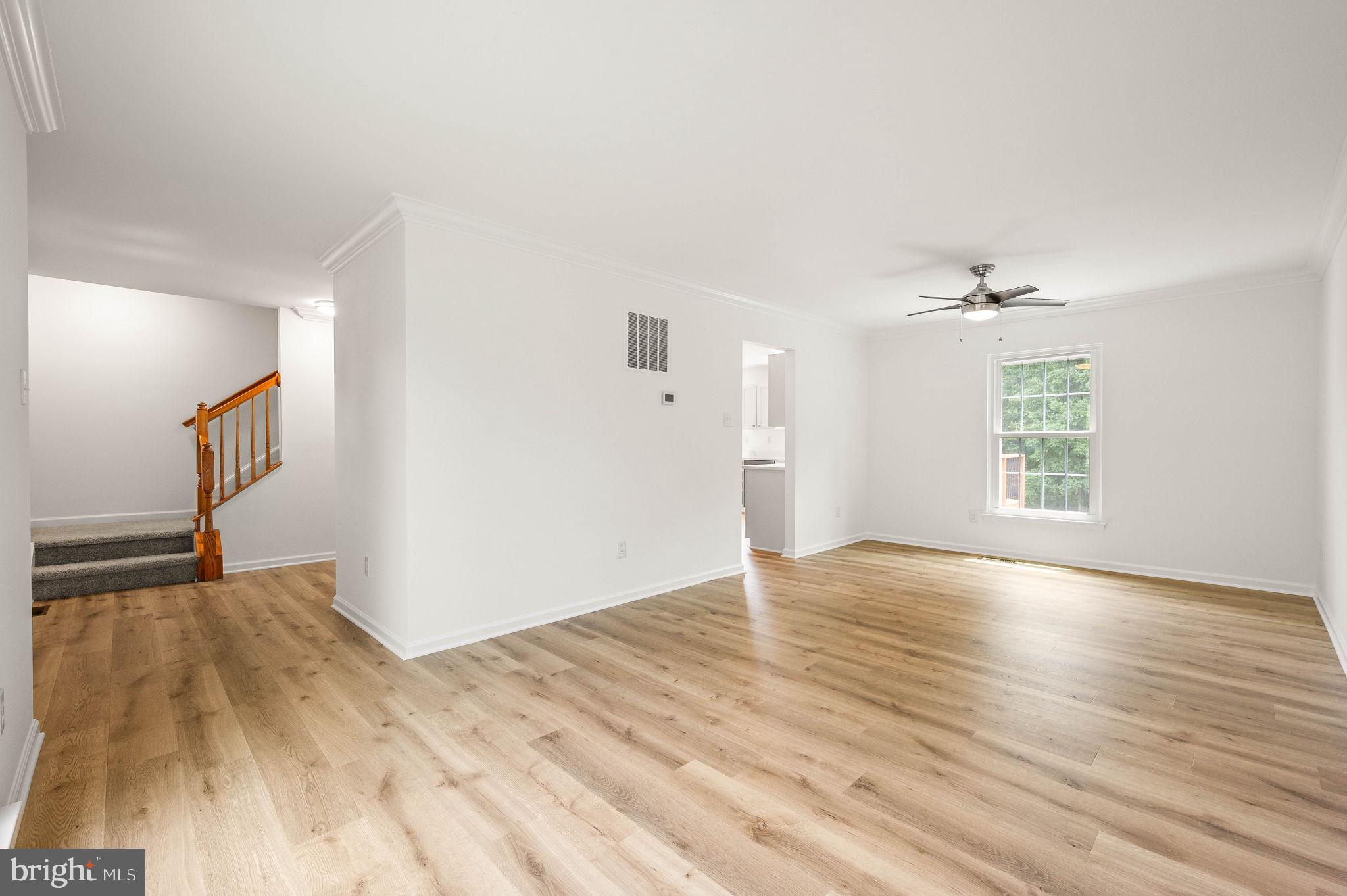 420 Winding Stream Road Spring City, PA 19475 - Photo 6 of 45 an empty room with wooden floor cabinet and windows
