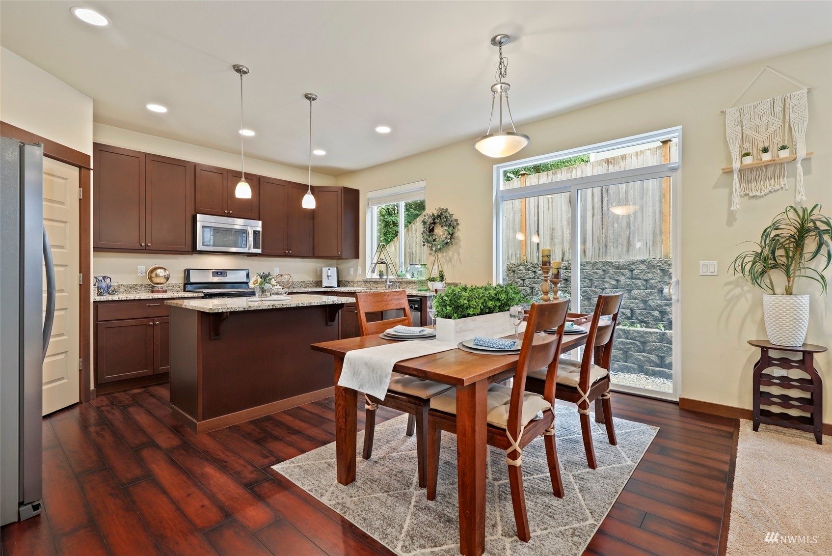 20220 3rd Drive Southeast Bothell, WA 98012 - Photo 13 of 37 a kitchen with stainless steel appliances granite countertop a stove a refrigerator a kitchen island a dining table and chairs