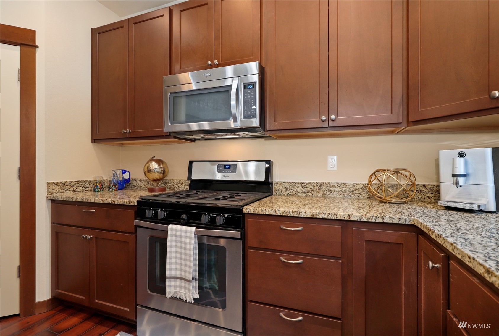 20220 3rd Drive Southeast Bothell, WA 98012 - Photo 15 of 37 a kitchen with granite countertop stainless steel appliances a stove a microwave and cabinets