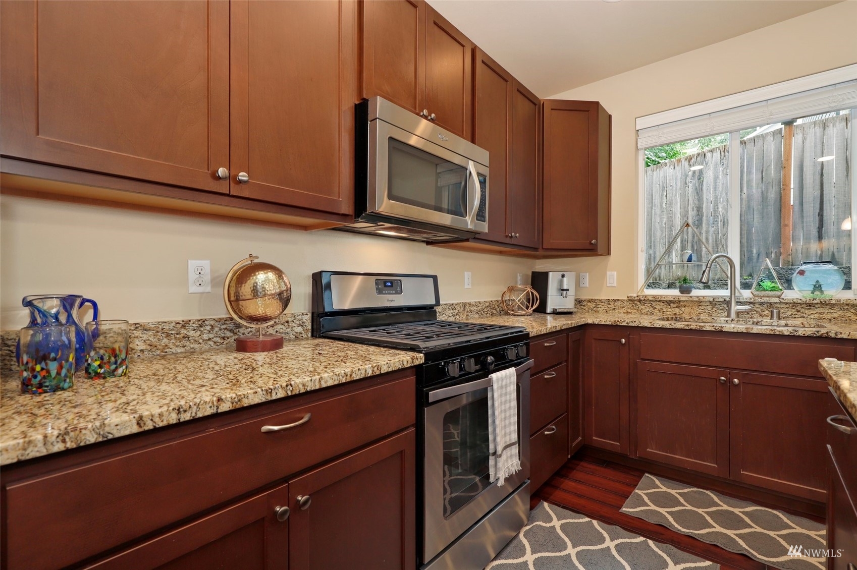 20220 3rd Drive Southeast Bothell, WA 98012 - Photo 16 of 37 a kitchen with granite countertop cabinets stainless steel appliances and a sink