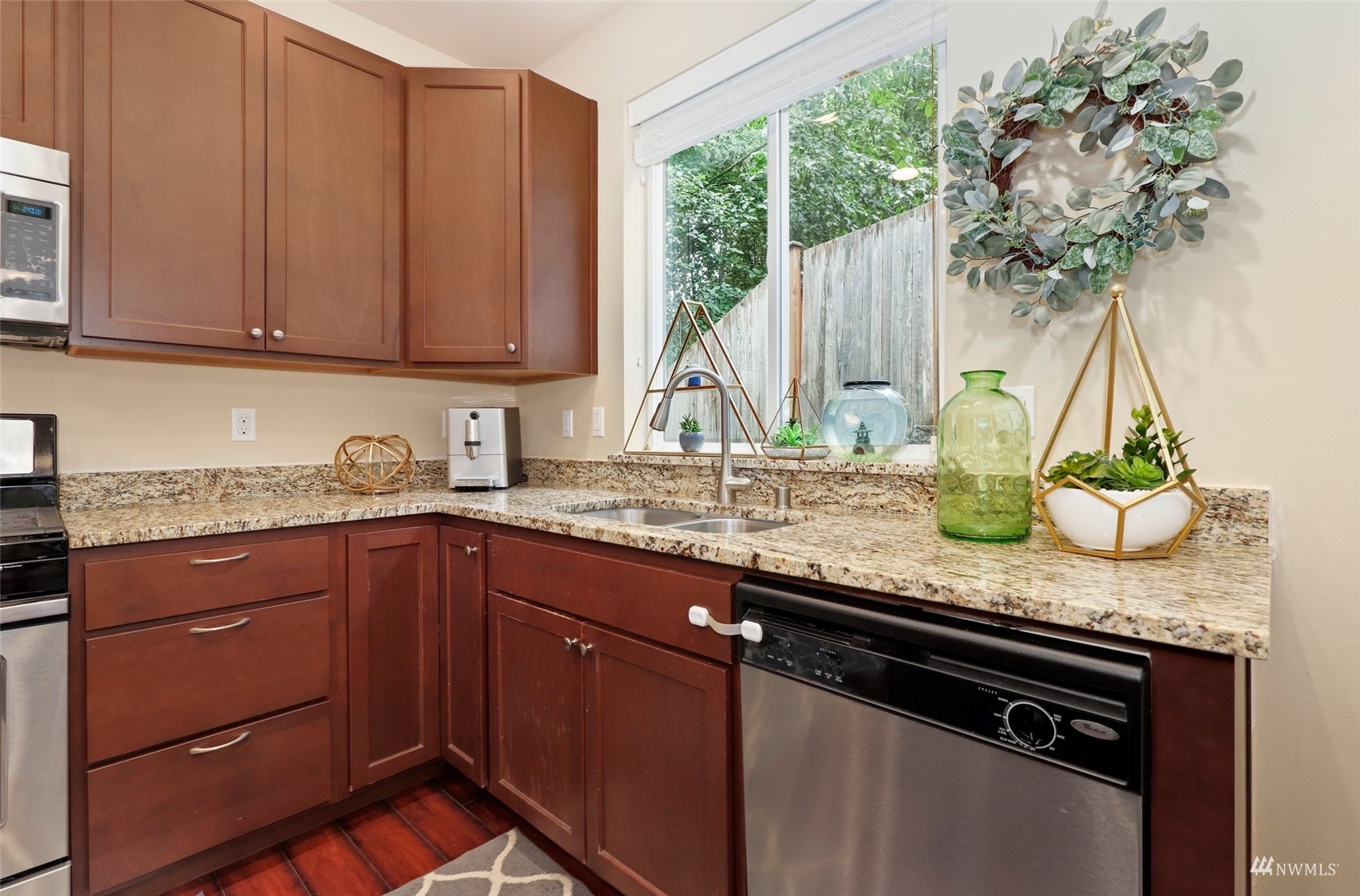20220 3rd Drive Southeast Bothell, WA 98012 - Photo 17 of 37 a kitchen with granite countertop a sink a counter space and cabinets