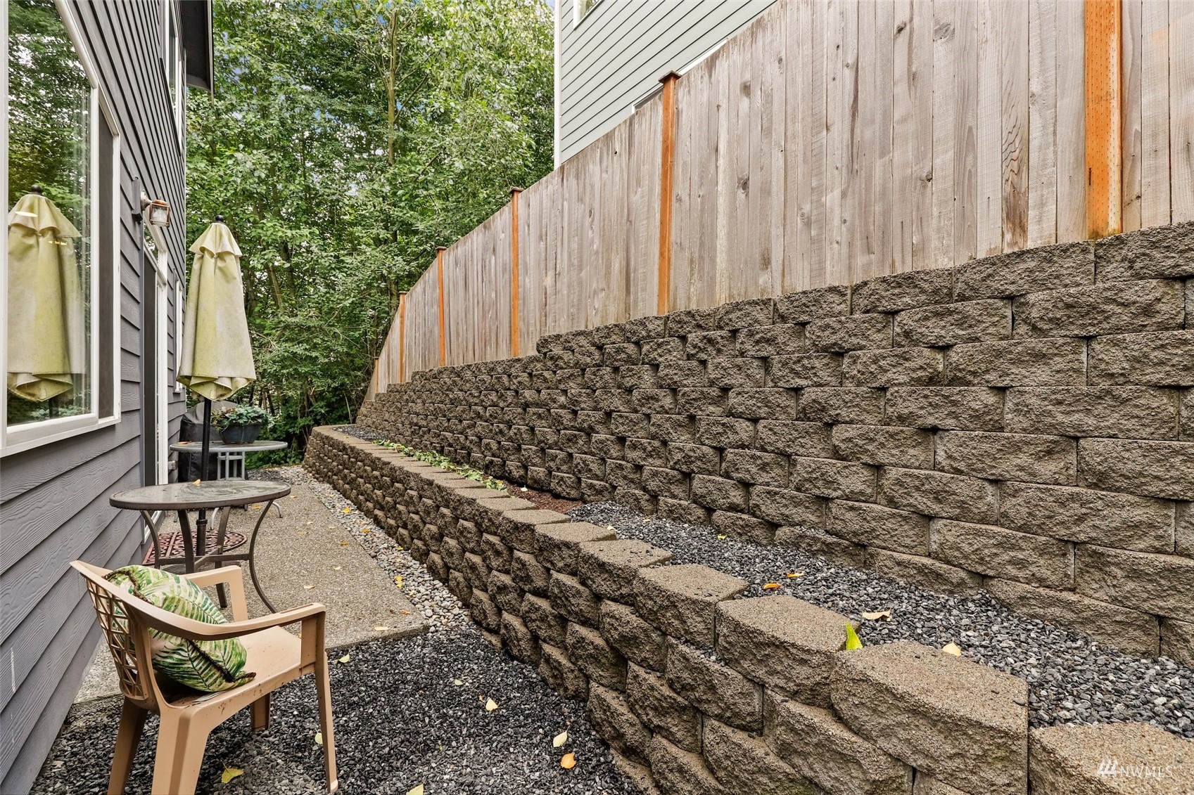 20220 3rd Drive Southeast Bothell, WA 98012 - Photo 31 of 37 a view of a patio with table and chairs with wooden fence and plants