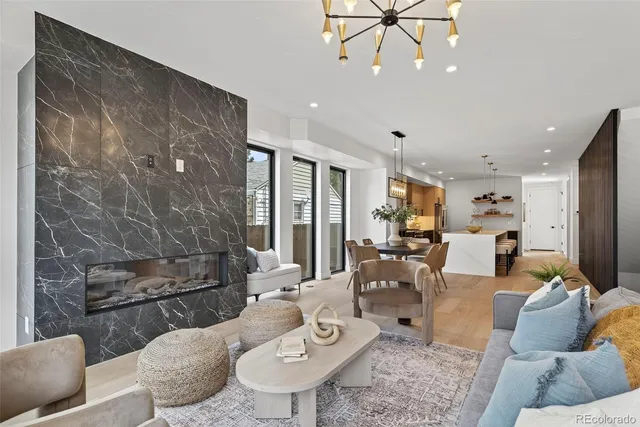 a living room with furniture and a chandelier