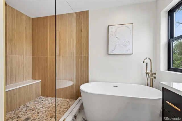 a bathroom with a sink a window and a shower