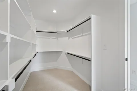 a view of walk in closet with empty racks