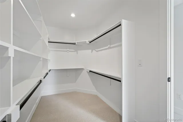 a view of walk in closet with empty racks