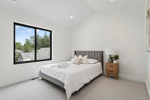 a bedroom with a bed and window