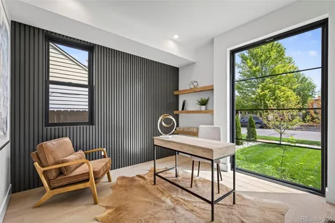 a view of a workspace with furniture and a window