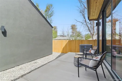 a balcony with table and chairs