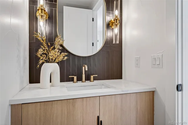 a bathroom with mirror and sink