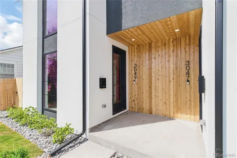 a view of outdoor space with sliding door and tree in back