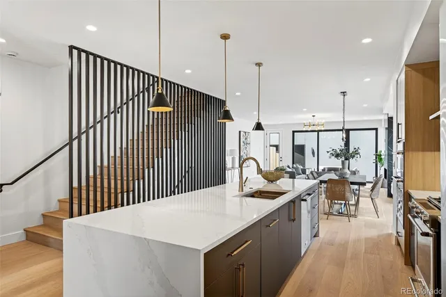 a kitchen with a table chairs stove and wooden floor