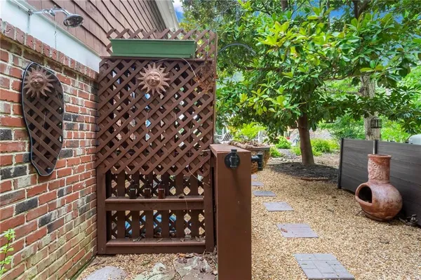 a view of a deck with chairs a barbeque grill with wooden fence