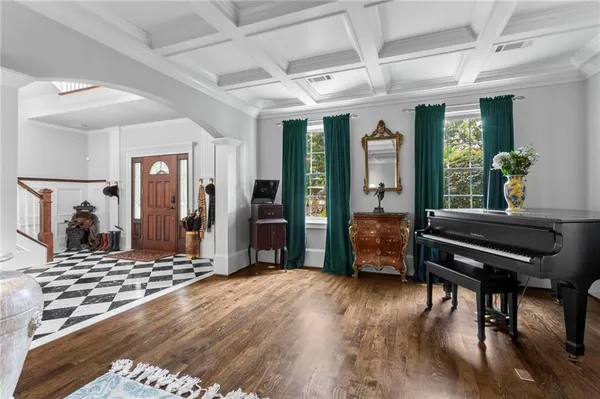 a living room with furniture a window and a flat screen tv