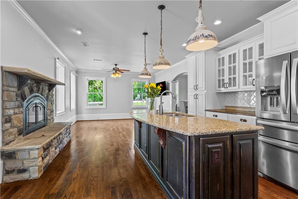285 Old Hornage Road Ball Ground, GA 30107 - Photo 25 of 64 a kitchen with stainless steel appliances granite countertop a sink a stove and a wooden floors